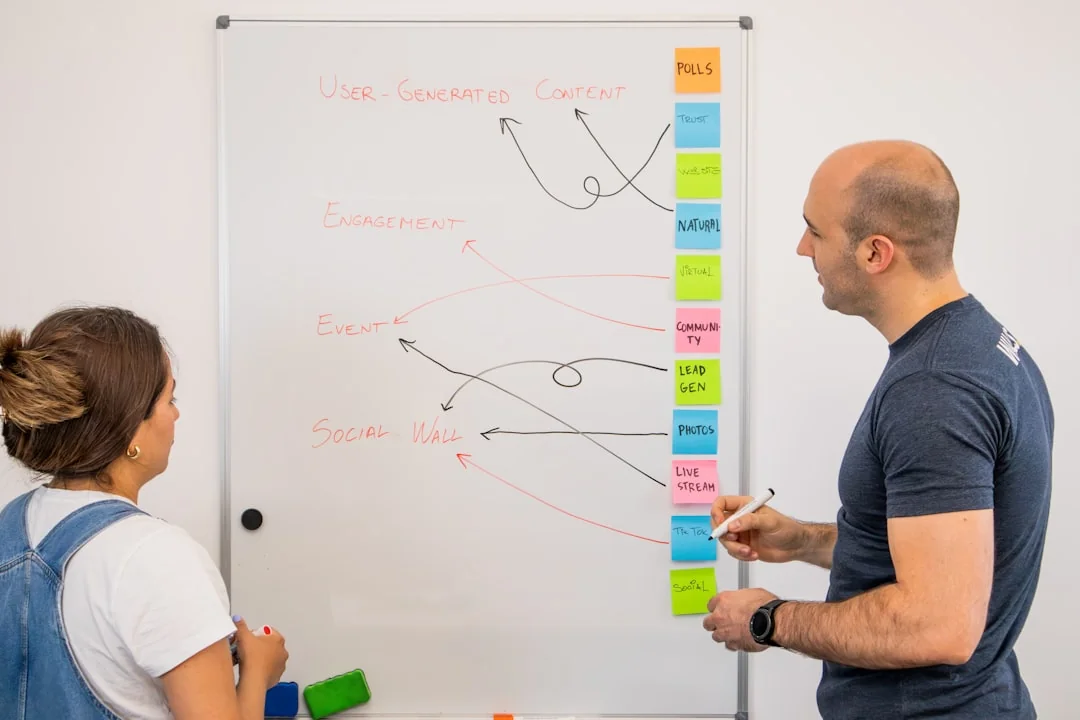 A modern workspace showing hands analyzing marketing data on a laptop and paper documents.